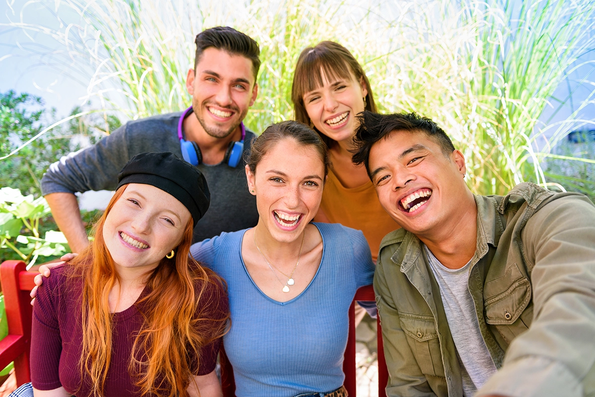 positive-young-diverse-friends-smiling-while-takin